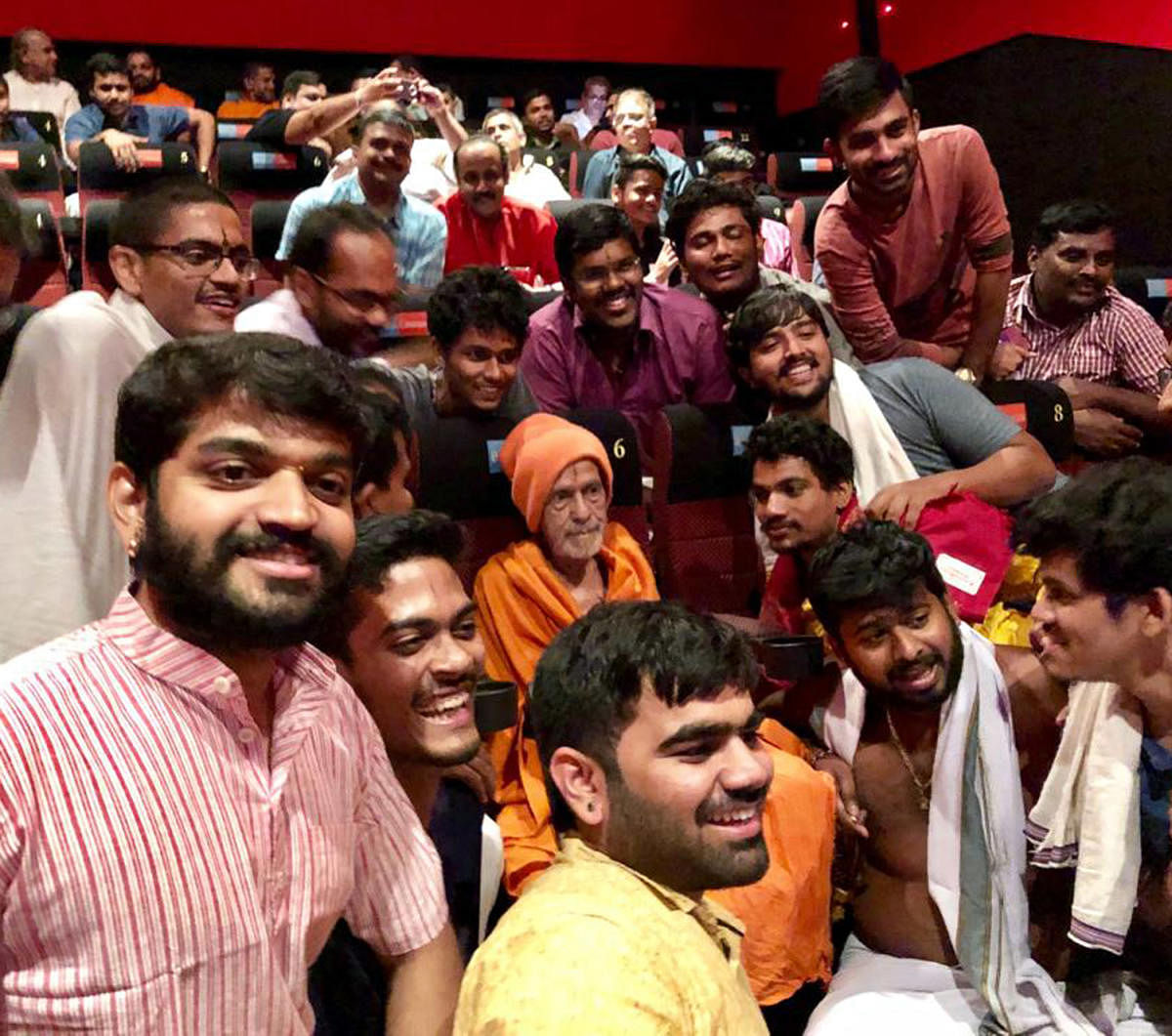 Pejawar Mutt seer watches Hindi film Uri with his followers in Manipal on Thursday night.