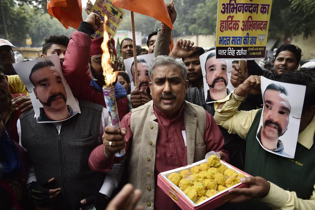 BJP workers celebrate the return of Indian Air Force Wing Commander Abhinandan Varthaman, who was captured by Pakistan during aerial combat, in New Delhi on Saturday. (PTI Photo)
