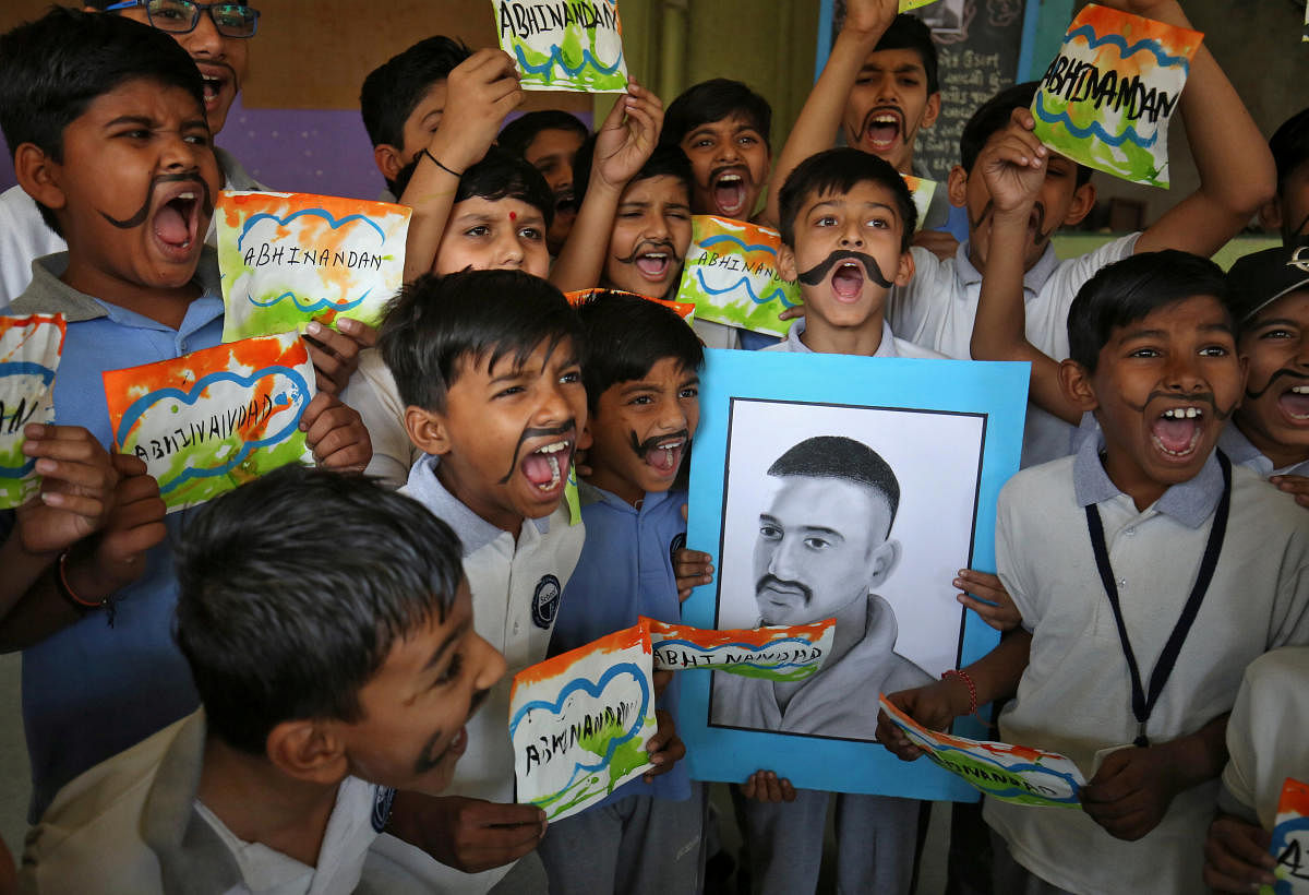 School children react as they celebrate the release of Indian Air Force pilot Wing Commander Abhinandan Varthaman by Pakistan on Friday, during a ceremony inside a school in Ahmedabad, India, March 2, 2019. (REUTERS)
