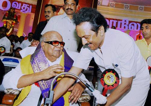 DMK chief M Karunanidhi and his son MK Stalin during party's 10th State Conference in Tiruchirapalli on Sunday. PTI Photo by Senthil
