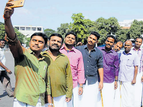 Government employees in Tamil Nadu take a selfie on World Dhoti Day on Wednesday. DH PHOTO