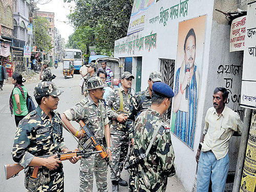 SSB personnel talk to a voter in Kamarhati Assembly Consituency of North 24 Pargana District in West Bengal on Monday. PTI