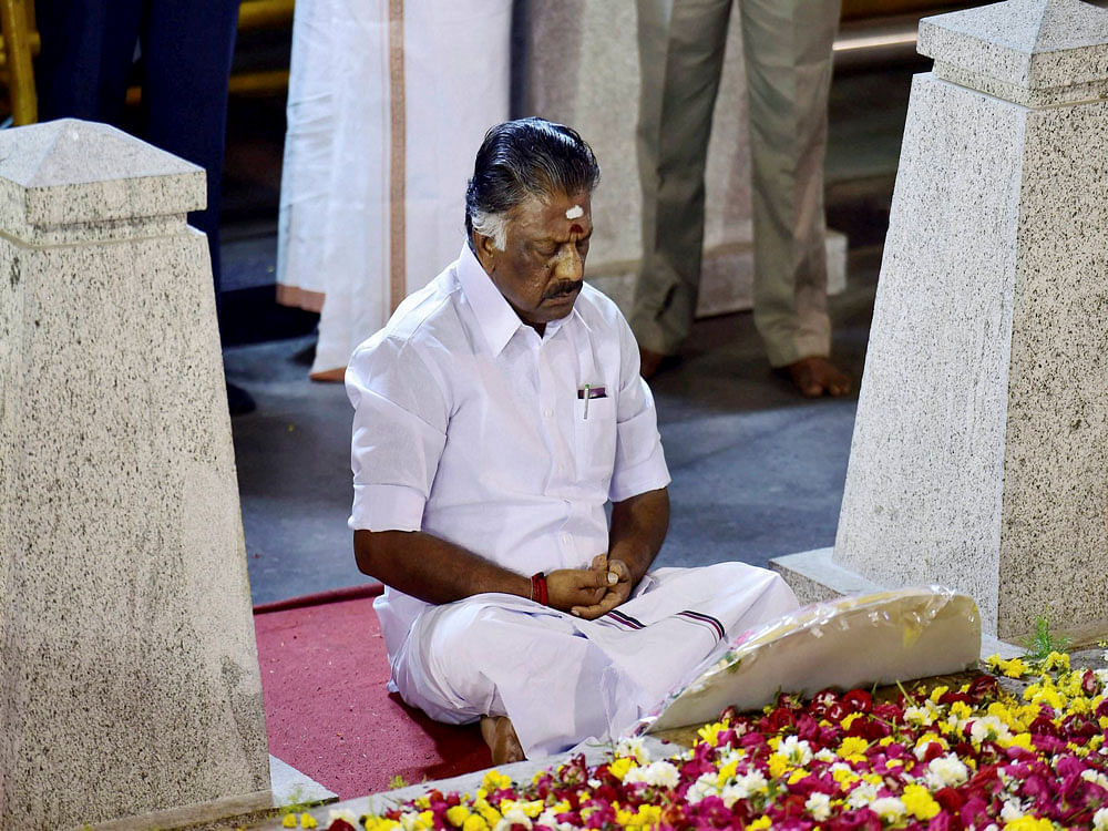Tamil Nadu Chief Minister O Panneerselvam sitting in a meditation in front of late J Jayalalithaa's burial site at the Marina Beach in Chennai on Tuesday. On Sunday, he tendered his resignation from the post paving the way for AIADMK General Secretary V K Sasikala to become Chief Minister. PTI Photo