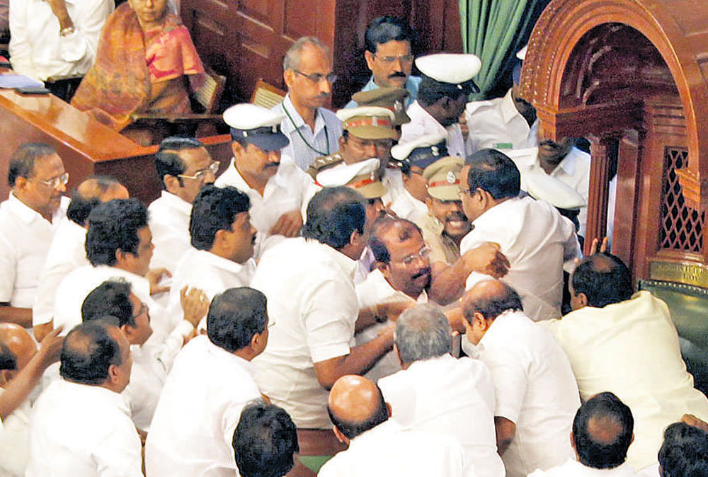 Speaker P Dhanapal being escorted out of the House as DMK MLAs turn violent in the Tamil Nadu Assembly on Saturday. DH Photo