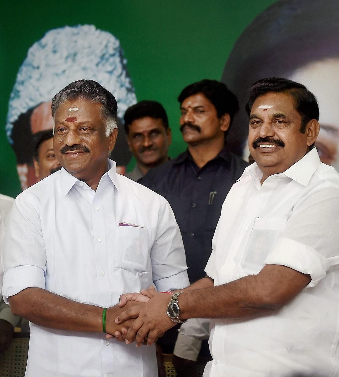 Chennai: Tamil Nadu Chief Minister K Palaniswami (R) and O Panneerselvam exchange greetings following merger of their factions in Chennai on Monday. All India Anna Dravida Munnetra Kazhagam factions led by Chief Minister Edappadi K Palaniswamy and former Chief Minister O Panneerselvam formally merged following a power sharing arrangement with the former to remain as Chief Minister and the latter his deputy. PTI Photo by R Senthil Kumar (PTI8_21_2017_000118B)