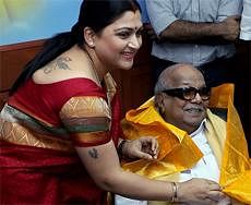 Tamil film actress Khushboo presenting a shawl to Tamil Nadu Chief Minister and DMK President M Karunanidhi after joining the party in Chennai on Friday. PTI