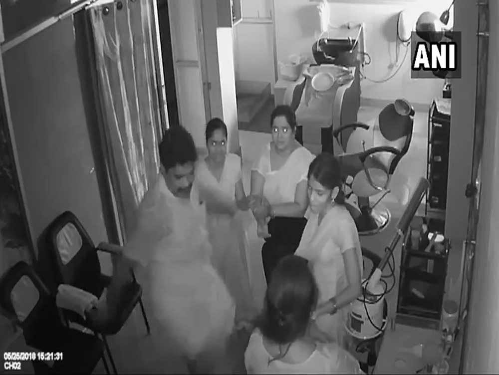 In the short video which went viral Thursday, the man clad in a white shirt and dhoti is seen repeatedly kicking the woman and pushing her down in the parlour in Perambalur, about 300 km from here. Image courtesy ANI/Twitter