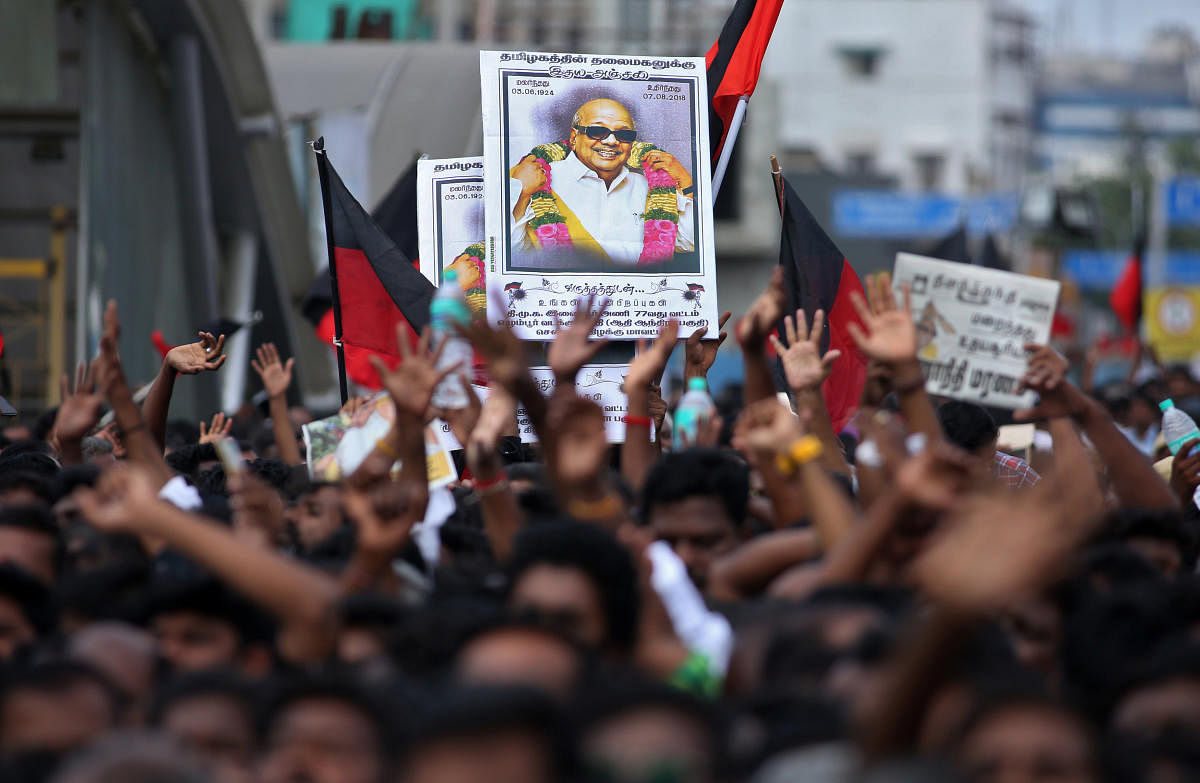 Supporters hold the portrait of the Indian Tamil leader Muthuvel Karunanidhi during his funeral in Chennai, India August 8, 2018. REUTERS/P.Ravikumar