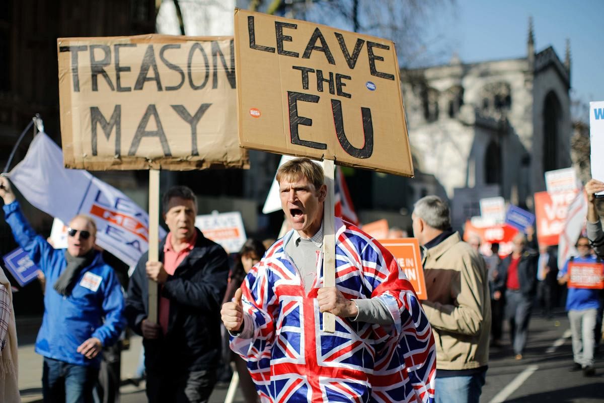 Pro-Brexit activists march outside the Houses of Parliament in central London. Lawmakers who voted down Prime Minister Theresa May's European Union withdrawal deal in January have outlined demands for a revised treaty to ensure their support. (AFP Photo)
