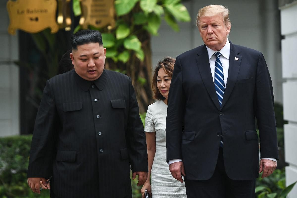 US President Donald Trump (R) walks with North Korea's leader Kim Jong Un during the second US-North Korea summit at Hanoi on February 28, 2019. AFP