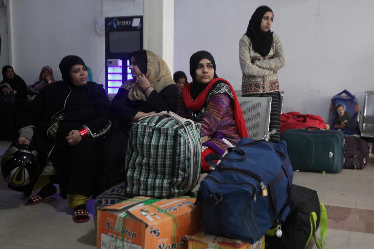 Passengers from India with their belongings wait for Samjhauta Express train which is temporarily suspended after Pakistan shot down two Indian military aircrafts, according to Pakistani officials, at the railway station in Lahore, Pakistan February 28, 2