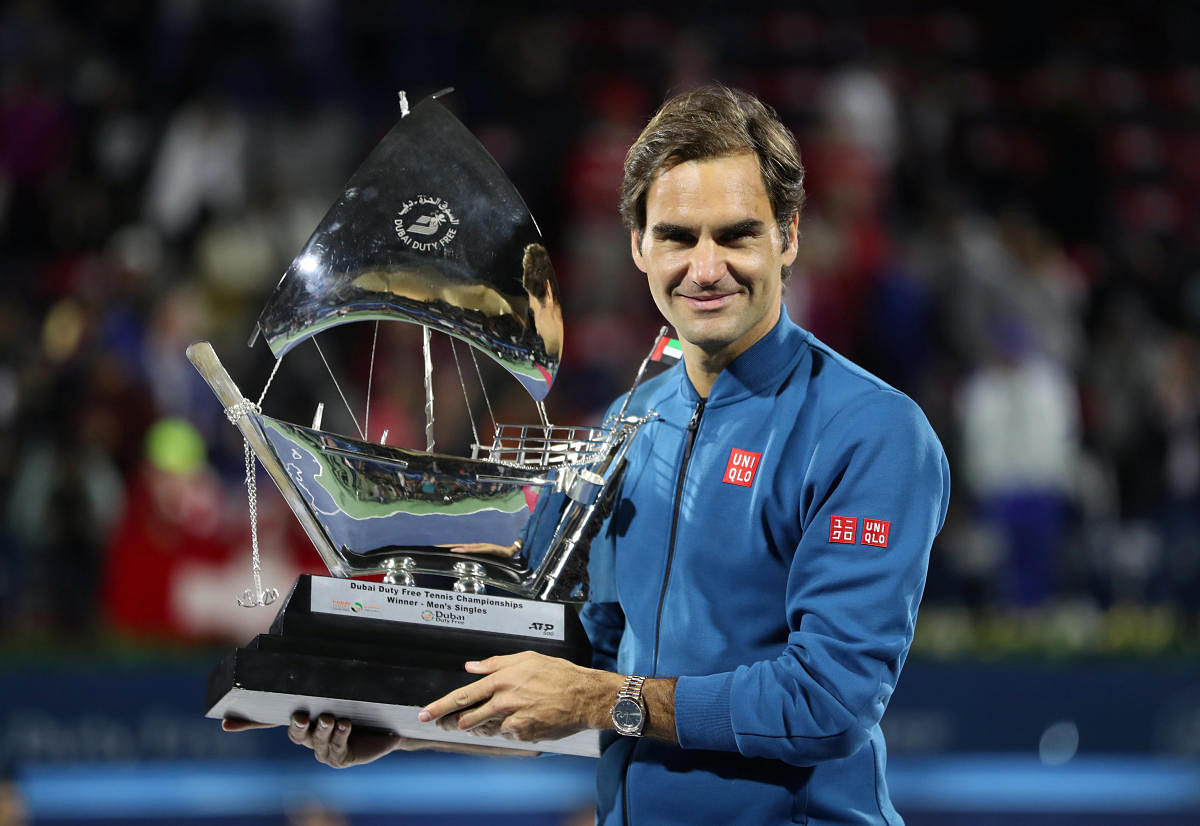 Switzerland's Roger Federer with the Dubai Tennis Championship Trophy after beating Greece's Stefanos Tsitsipas in the final on Saturday. REUTERS 