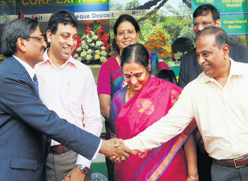 Corporation BankCMDS R Bansal greets Karnataka State Industrial and Infrastructure Development Corporation Ltd CMDV P Baligar at the inauguration of the banks Race Course Road e-Lobby in Bangalore on Wednesday. DH photo