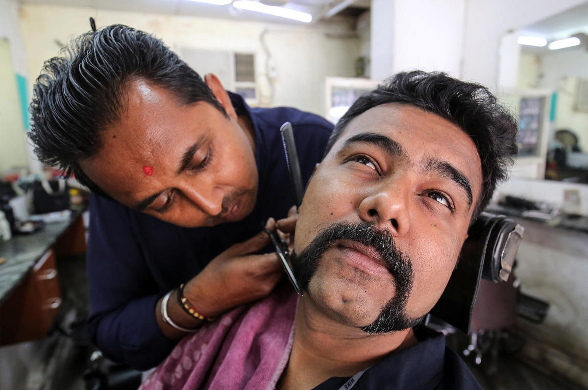 Dhiren Makvana gets his moustache trimmed similar to the one sported by Indian Air Force pilot Abhinandan Varthaman, who was captured and later released by Pakistan, inside a salon in Ahmedabad, India, March 4, 2019. (REUTERS)