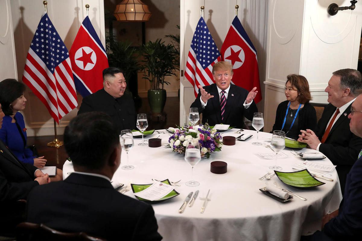 U.S. President Donald Trump and North Korean leader Kim Jong Un sit down for a dinner during the second U.S.-North Korea summit at the Metropole Hotel in Hanoi, Vietnam February 27, 2019. Also pictured at right are U.S. Secretary of State Mike Pompeo and