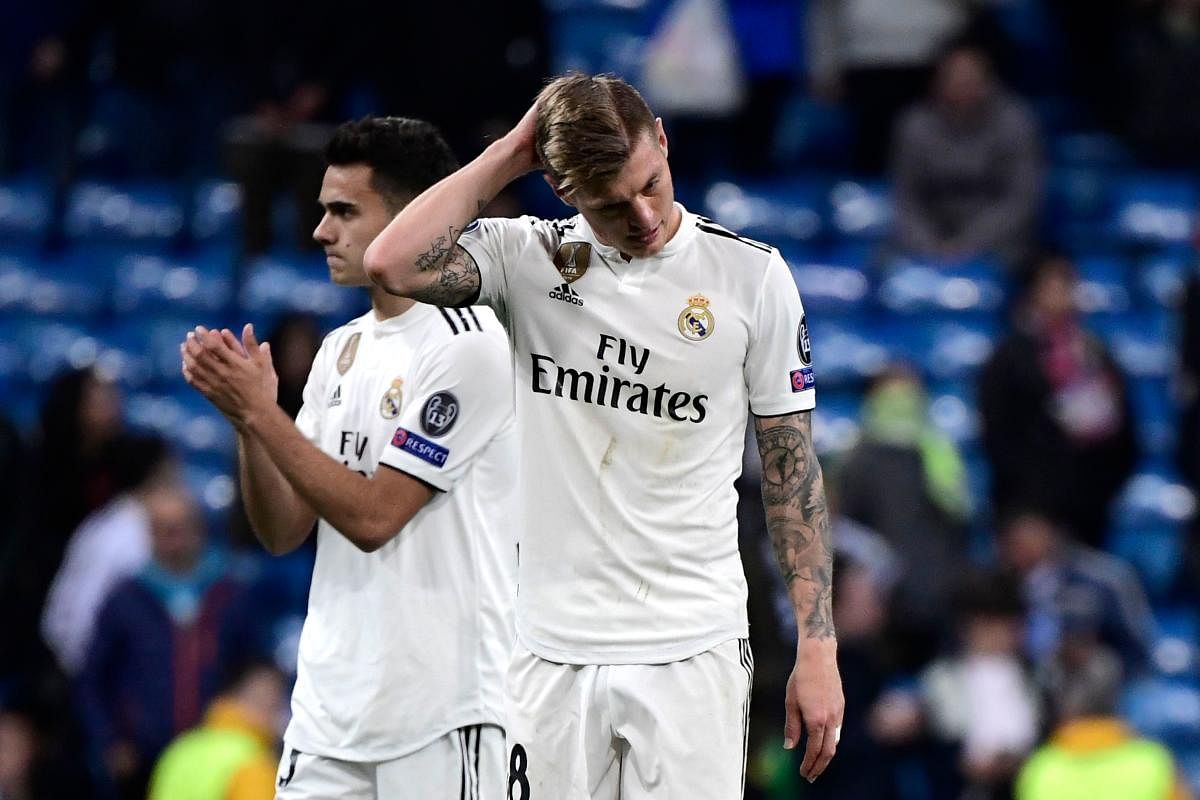 Real Madrid's German midfielder Toni Kroos (R) and Real Madrid's Spanish defender Sergio Reguilon react at the end of the UEFA Champions League round of 16 second leg football match between Real Madrid CF and Ajax at the Santiago Bernabeu stadium in Madri