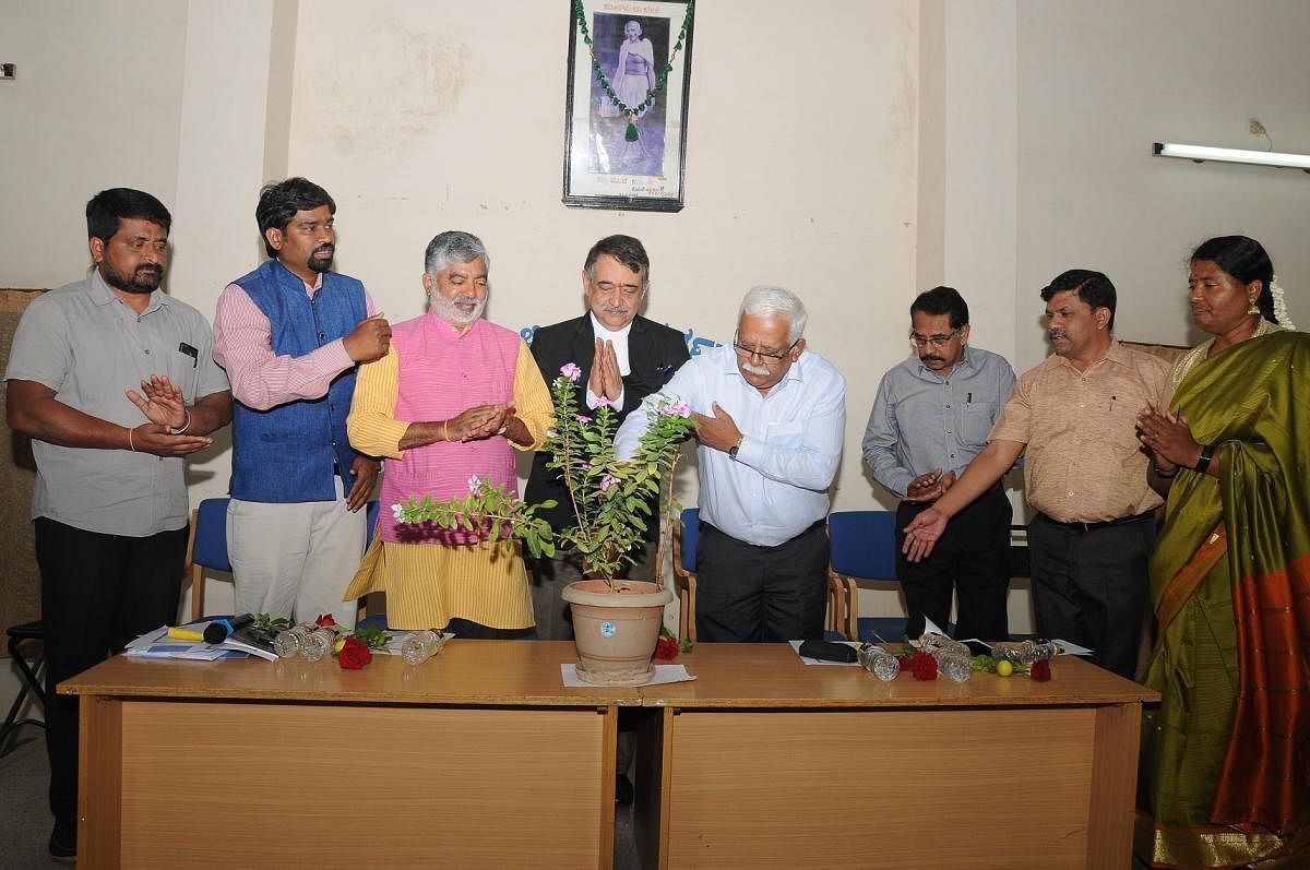 Retired Deputy Commissioner of RAW Mohan Subbaiah inaugurates the interaction programme on 'Article 370 -- Raddati Ayamagalu Mathu Paramarshe', in Mysuru, on Wednesday. RAW ex-officer David, president of Rajya Shaikshanika Diksuchi Mathu Sudharana Samiti