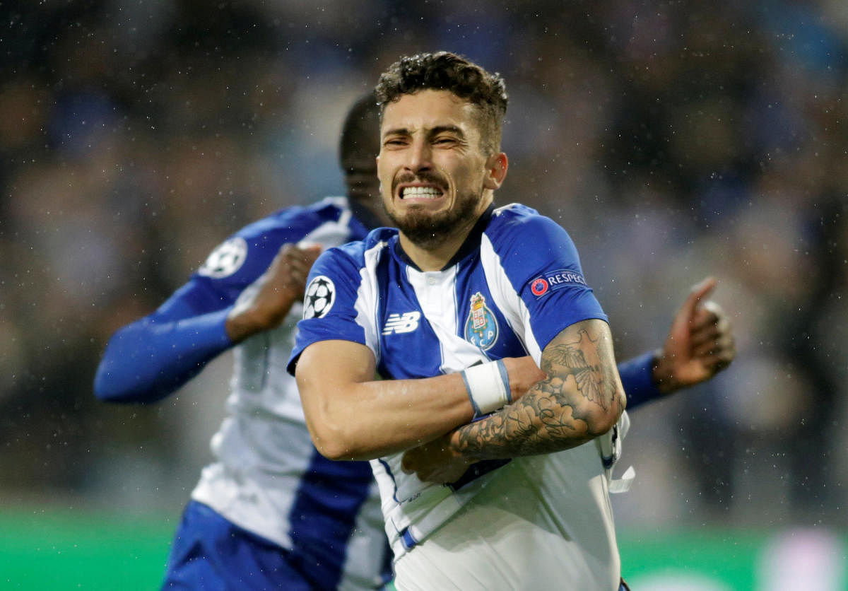 THRILLING END: Porto's Alex Telles celebrates after converting the decisive penalty against AS Roma. Reuters 