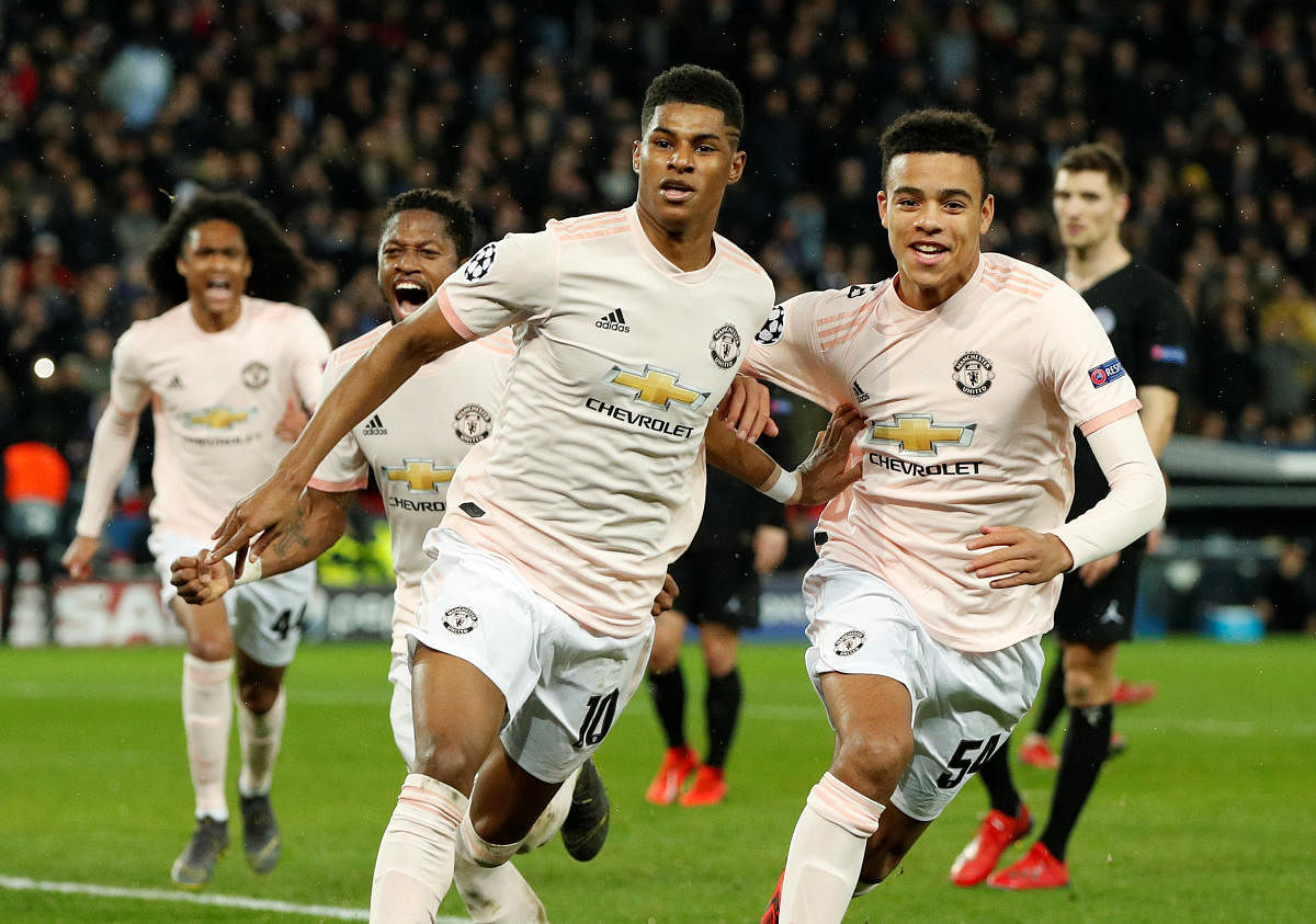 Manchester United's Marcus Rashford celebrates scoring their third goal with Mason Greenwood and Fred. (Reuters)
