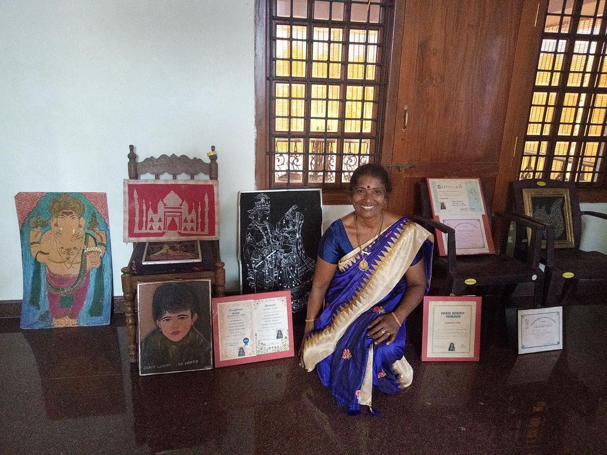 Sudha S Shetty with her many art works and certificates won by her.