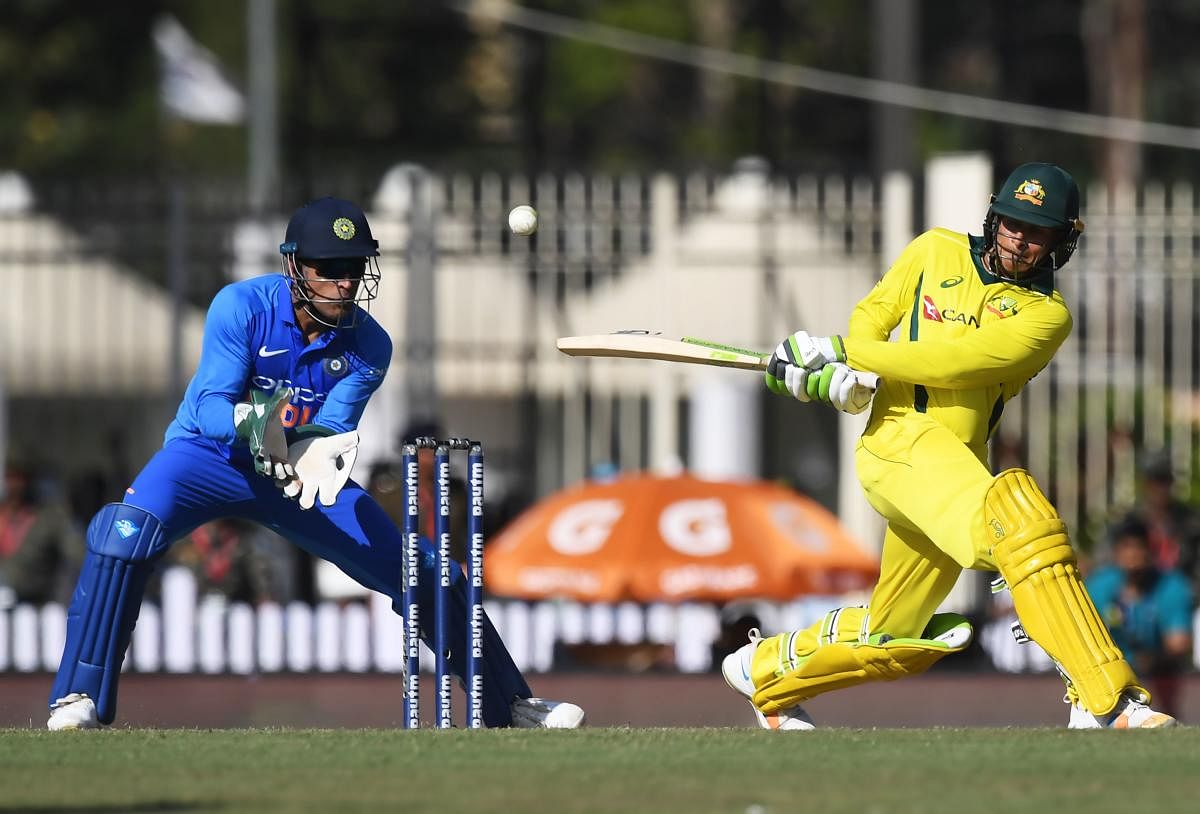 Australian cricketer Usman Khawaja (R) plays a shot during the third one-day international (ODI) cricket match between India and Australia at the Jharkhand State Cricket Association International Cricket Stadium, in Ranchi. AFP photo