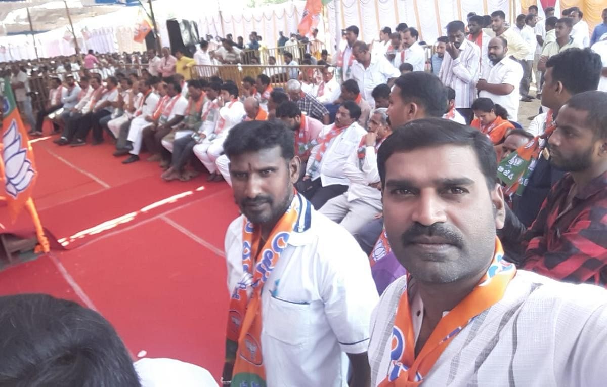 A BJP worker takes a selfie during the meeting of Shakthi Kendra Pramukhs, on JK Grounds in Mysuru on Wednesday.