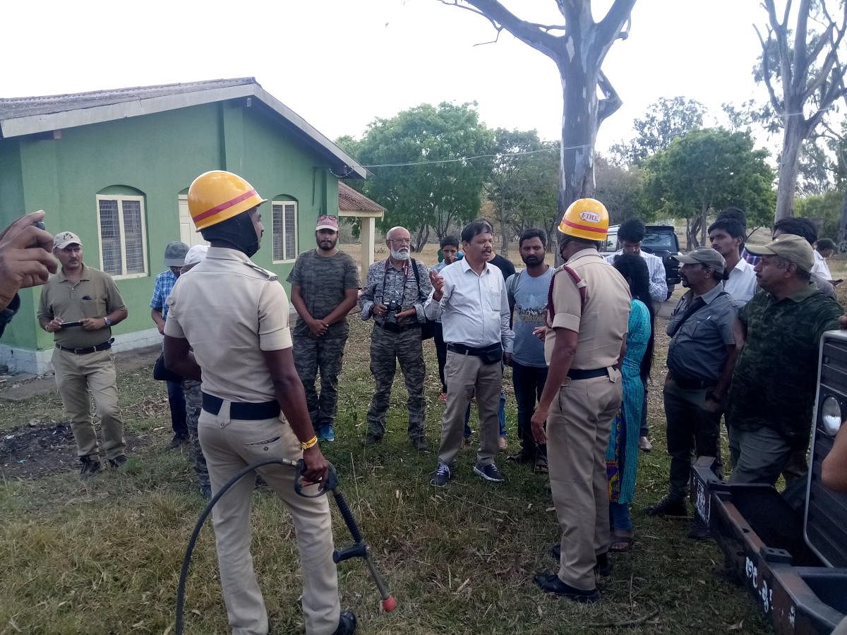 Fire and Emergency Services personnel demonstrate techniques of firefighting, at Bandipur on Thursday. Adjunct faculty at Karnataka Forest Academy, also retired assistant conservator of forests, S Chandrashekar is seen.