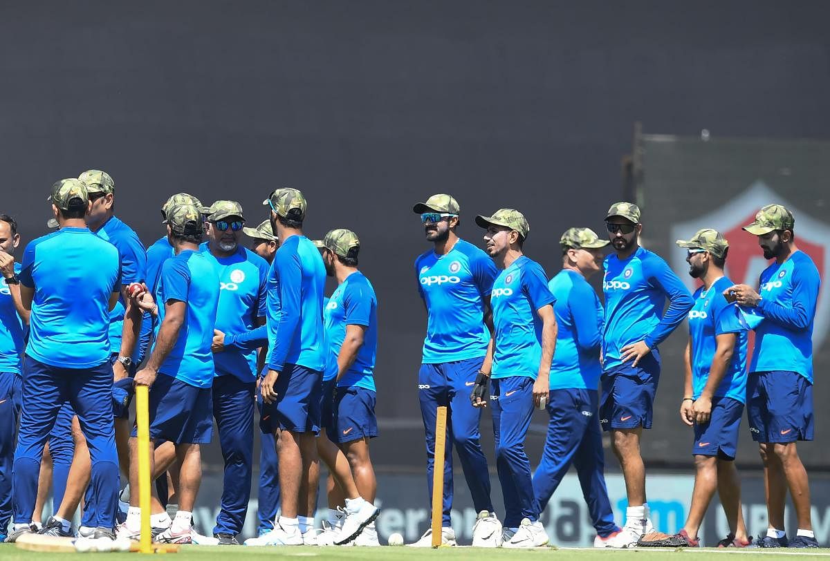 Indian cricketers wear camouflage army caps ahead of the third one-day international (ODI) cricket match between India and Australia at the Jharkhand State Cricket Association International Cricket Stadium in Ranchi. AFP