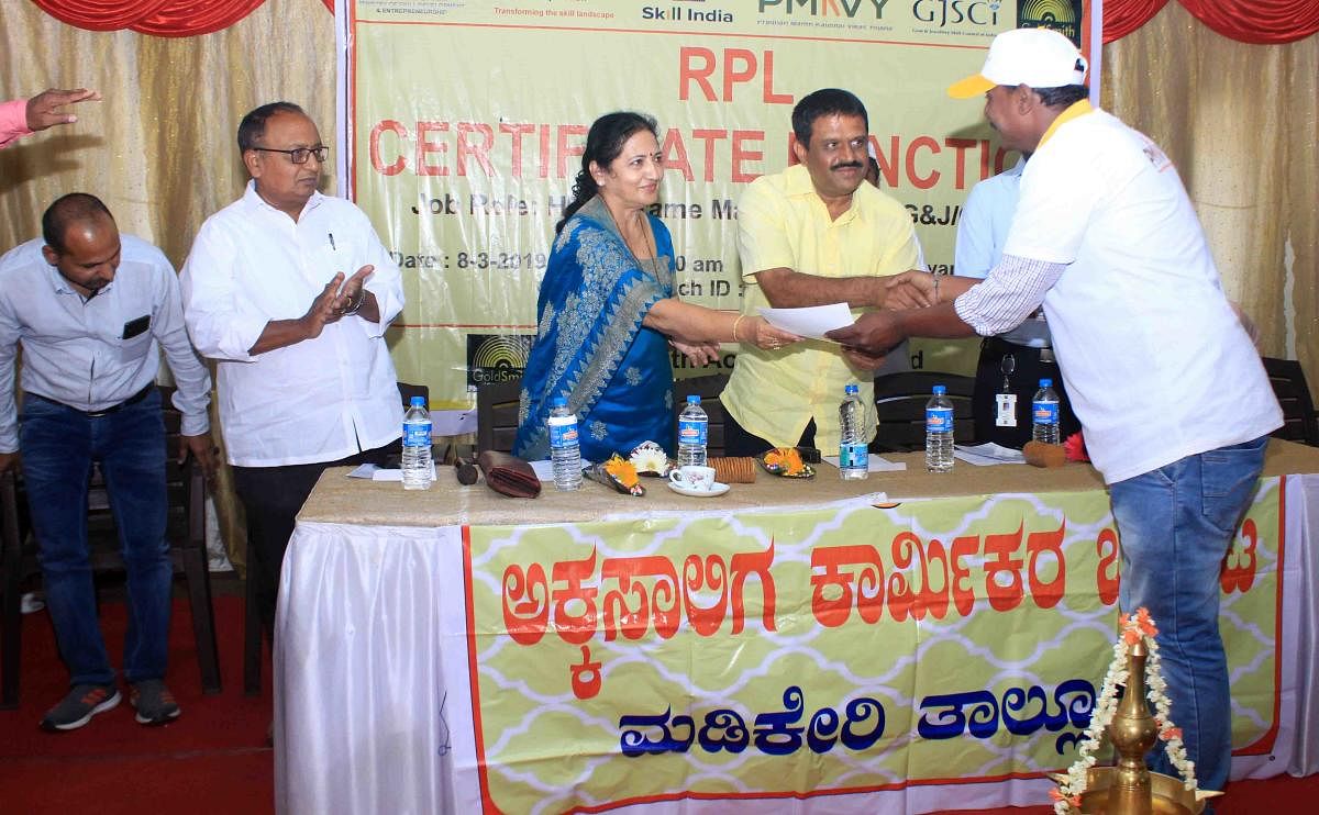 MLC Veena Acchaiah and MLA Appachu Ranjan hand over a certificate to a craftsman who underwent training conducted by the Skill Development and Entrepreneurship Ministry under the Central government, during a programme in Madikeri on Friday.