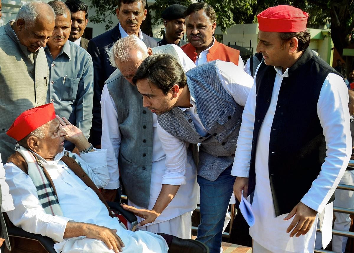 Samajwadi Party founder Mulayam Singh Yadav interacts with RLD vice-president Jayant Chaudhary as Samajwadi Party President Akhilesh Yadav looks on, before a press conference in Lucknow, Tuesday, March 5, 2019. (PTI Photo)