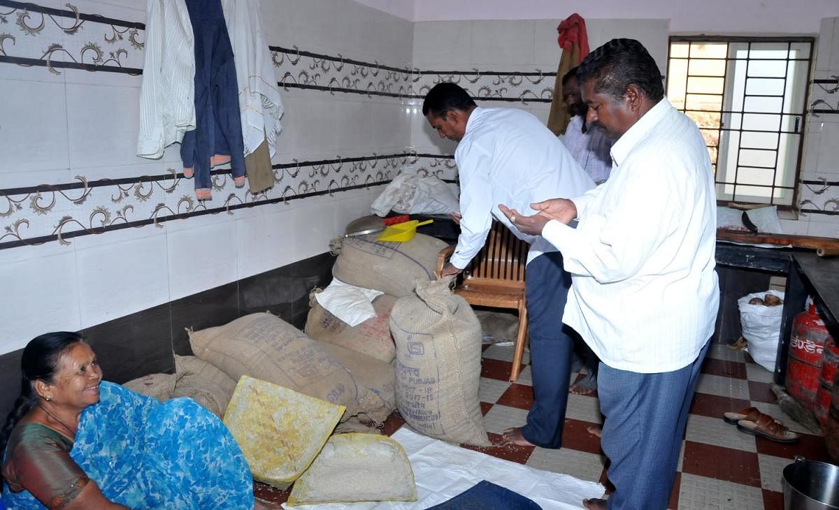 Zilla Panchayat Standing Committee on Social Justice president Hirigayya inspects the food grains at a hostel in Chikkamagaluru.