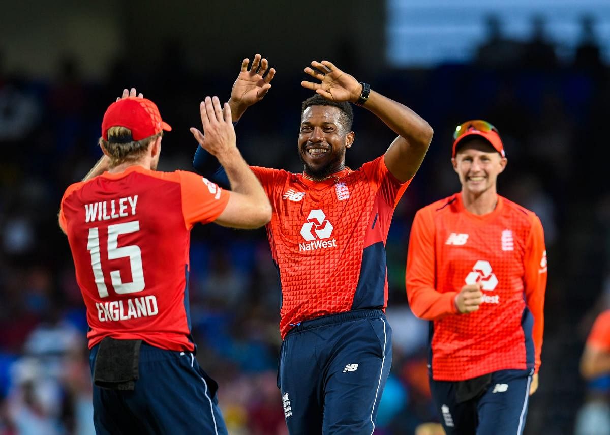 WRECKER IN CHIEF: England's Chris Jordan (centre) celebrates with team-mates after dismissing Nicholas Pooran of West Indies. AFP