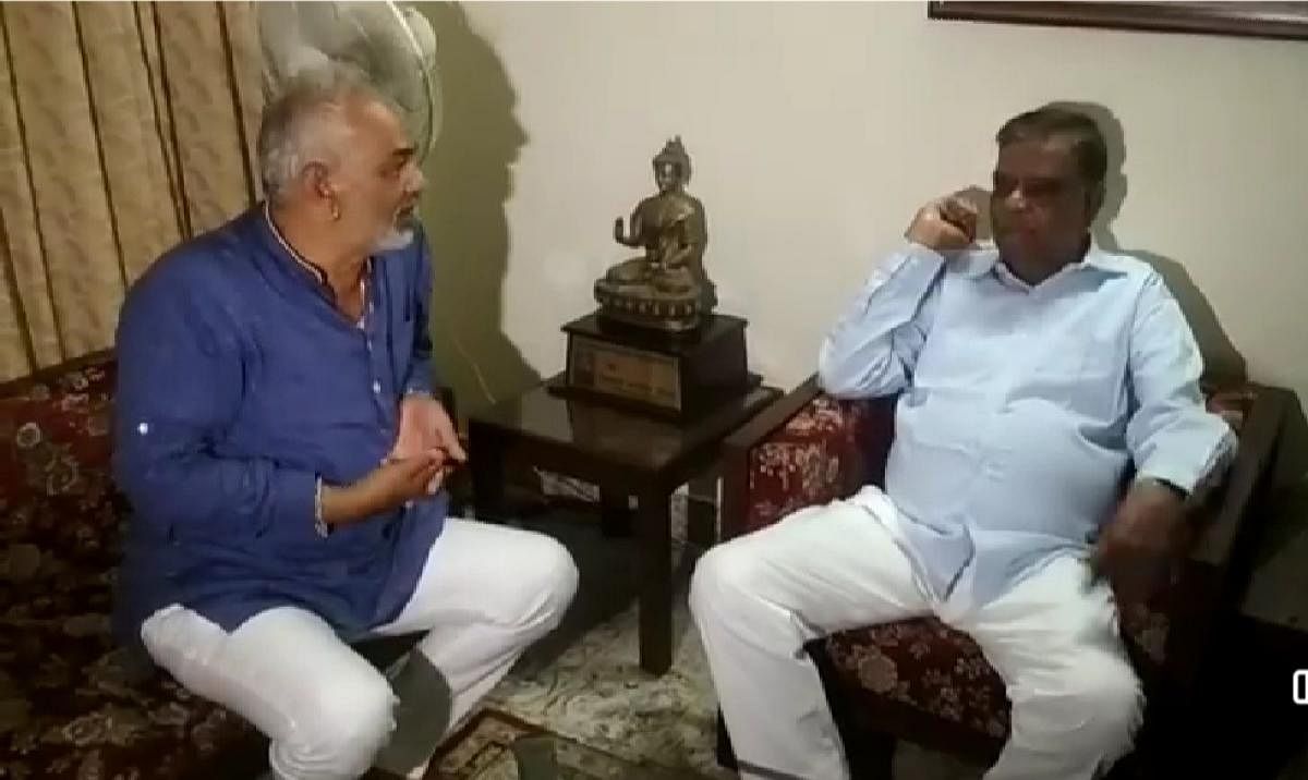 Former minister A Manju meets state vice president of BJP Srinivas Prasad in Mysuru on Saturday.