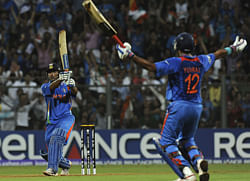 In this photograph taken on April 2, 2011, Indian captain Mahendra Singh Dhoni (L) hits a six to win against Sri Lanka as teammate Yuvraj Singh reacts during the Cricket World Cup 2011 final at The Wankhede Stadium in Mumbai. India's cricketers have been ordered to wear the same jersey design that won them the World Cup last year for next week's World Twenty20 in a bid to bring them good luck. Nike, the Indian team's clothing sponsor, had earlier this month unveiled a new Twenty20 design that displayed the national colours prominently and even paraded top stars in the new outfit at a media launch. AFP