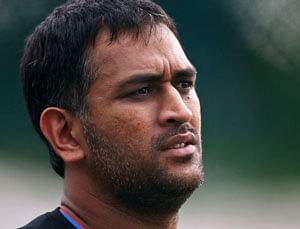 Indian cricket captain Mahendra Singh Dhoni stands on the field during a practice session in Hyderabad/ AP File Photo