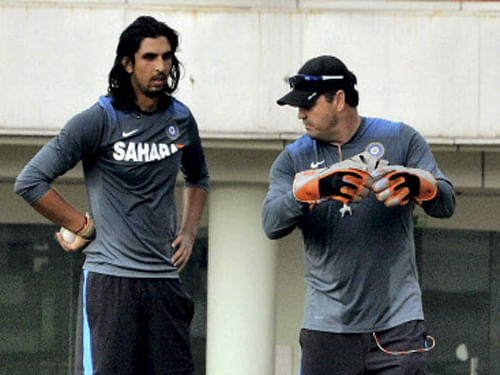 Ishant Sharma takes tips from bowling coach Joe Dawes during a practice session. PTI Photo