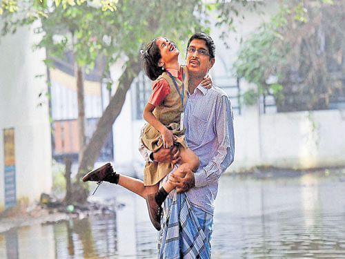 A student is carried to a school in Chennai as schools reopened on Monday. PTI