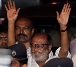 Superstar Rajinikanth waves to his supporters on his return to Chennai Airport on Wednesday night after undergoing a treatment at Singapore for several months. PTI Photo