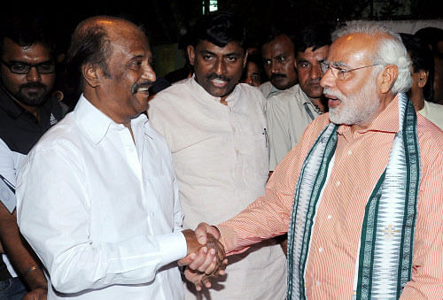 BJP Prime Ministerial candidate Narendra Modi shakes hands with superstar Rajinikanth at his residence in Chennai on Sunday. PTI Photo