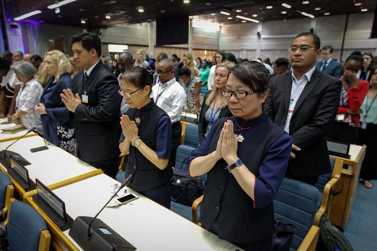 A handout photo by UNEP shows the UN Staff observing a minute of silence for the victims of the accident of the Ethiopian Airlines, including 19 UN workers, before the opening plenary of the 4th UN Environment Assembly at the UN headquarters in Nairobi, K