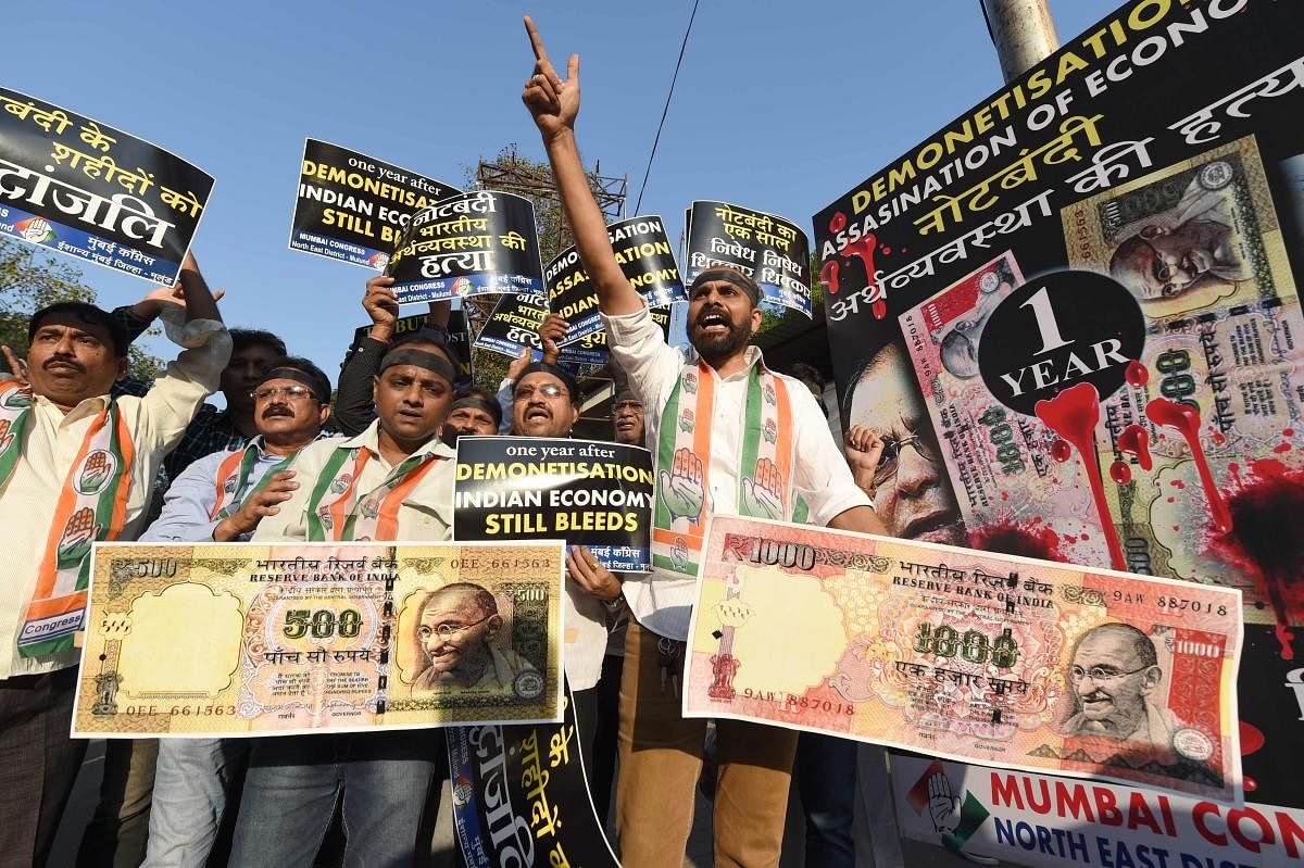 Congress supporters shout slogans and hold placards during a protest on the eve of the first anniversary of demonetisation scheme in Mumbai on November 7, 2017. AFP FILE