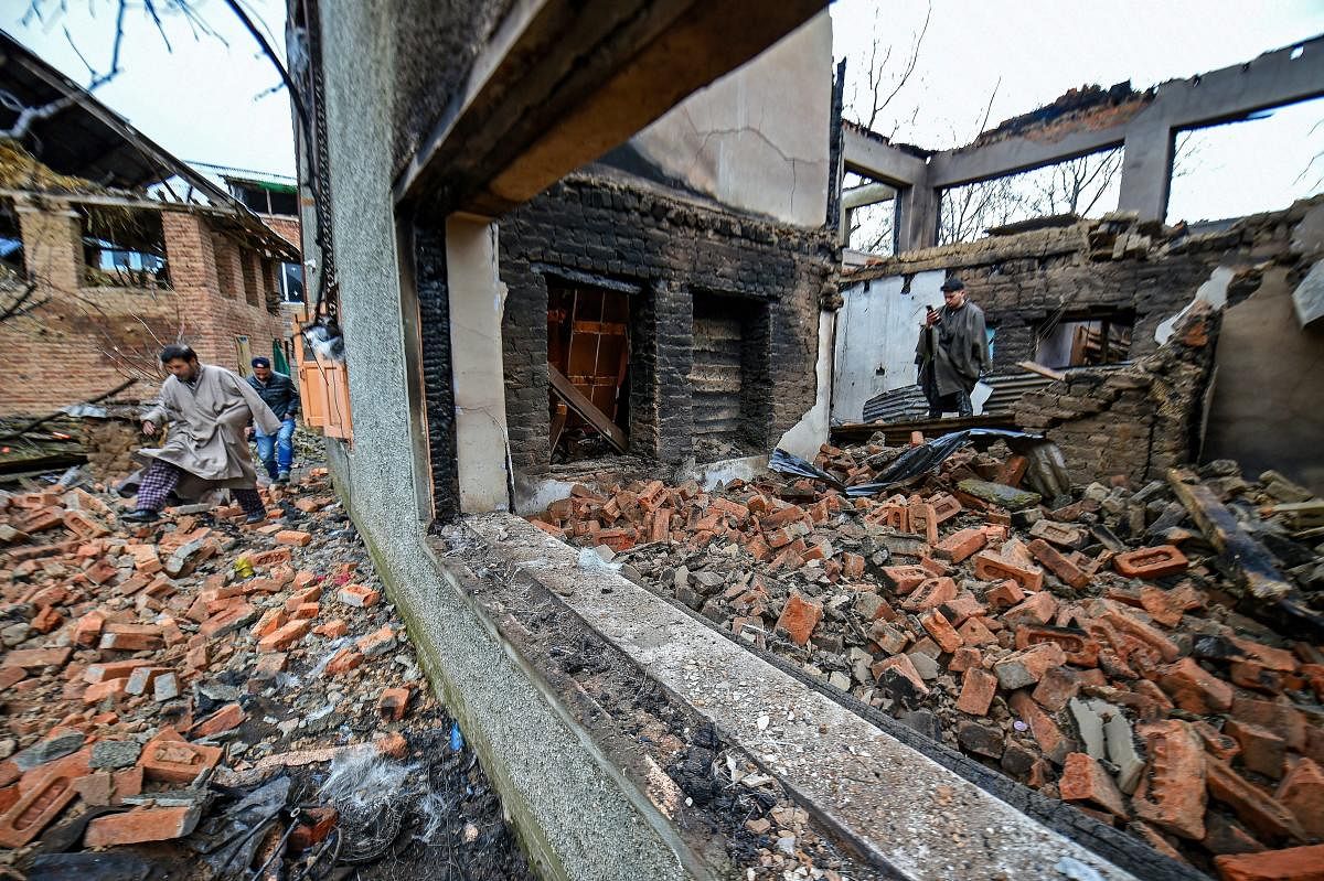 The debris of a destroyed house after a gunfight between security forces and militants at Pinglish area of Tral in Pulwama district of South Kashmir on Monday. PTI