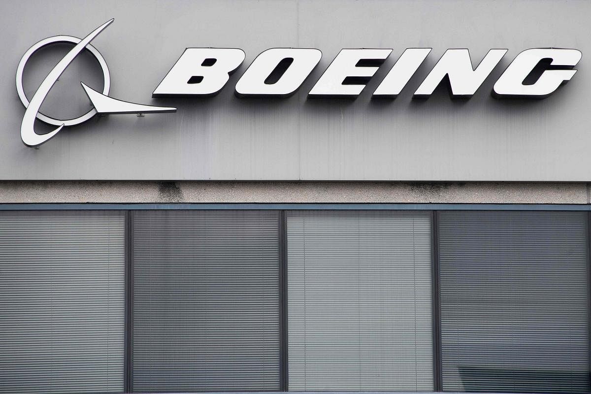 The Boeing Company logo is seen on a building in Annapolis Junction, Maryland, on March 11, 2019. Tumbling shares in US aviation giant Boeing on Monday tore a hole in the Dow Jones Industrial Average, sending the benchmark index into the red for a sixth d
