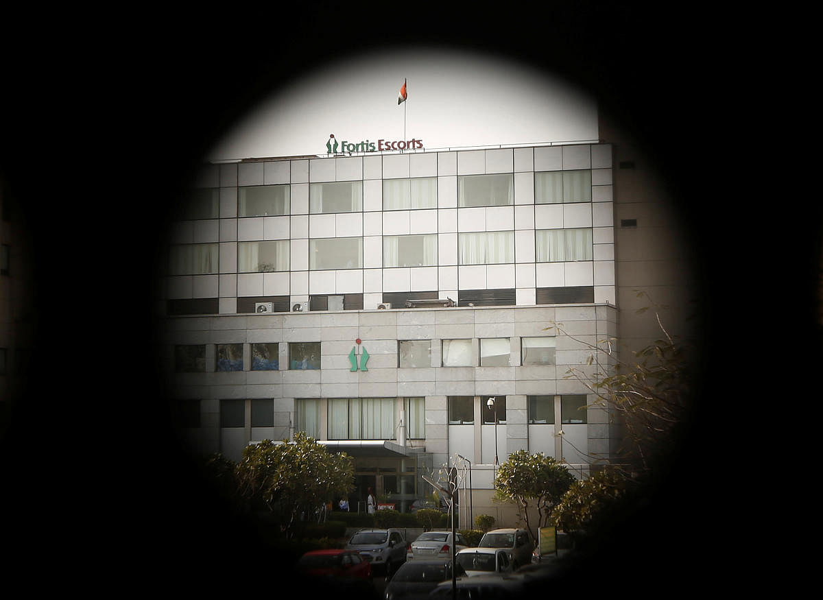 A Fortis hospital building is pictured through a fence in New Delhi. REUTERS
