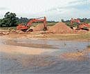 Unchecked: Sand lifting going unabated in river Hemavathy in Sakleshpur taluk. DH Photo