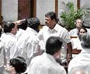 Finger-pointing: Excise Minister M P Renukacharya (right) in a heated argument with JD(S) MLCs in the Legislative Council on Thursday, after Chief Minister B S Yeddyurappa described the Gowda family as ''a curse on Karnataka''. DH Photo