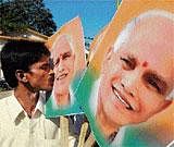 relief: A supporter kisses a poster of former chief minister B S Yeddyurappa who he was released from jail in Bangalore on Tuesday. dh Photo