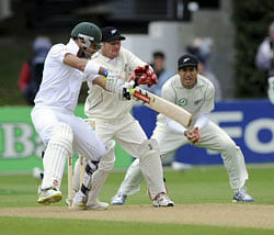 South Africa's J.P. Duminy, left, cuts in front of New Zealand wicket keeper Kruger van Wyk and Ross Taylor on the second day of the third international cricket test at the Basin Reserve in Wellington, New Zealand, on Saturday. AP