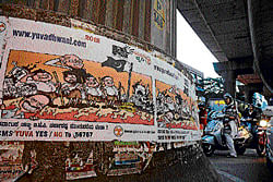 Defaced: A poster put up illegally on a Metro rail pillar in Trinity Circle.  DH Photo