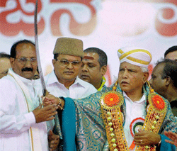 KJP Leader B S Yeduyurappa holds a sword during the launch of the Karnataka Janata Party in Haveri town on Sunday. PTI